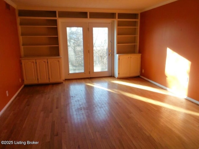 unfurnished room featuring baseboards and hardwood / wood-style floors