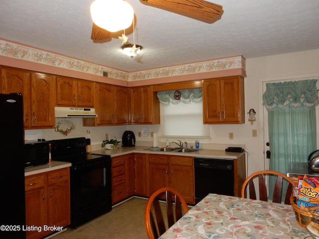 kitchen with sink, black appliances, and a textured ceiling