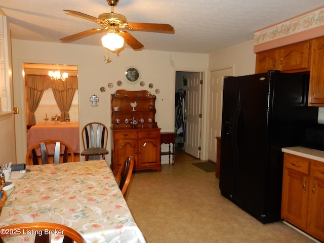 dining area with ceiling fan with notable chandelier