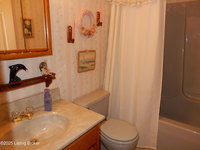 full bathroom with vanity, shower / bath combo, and toilet