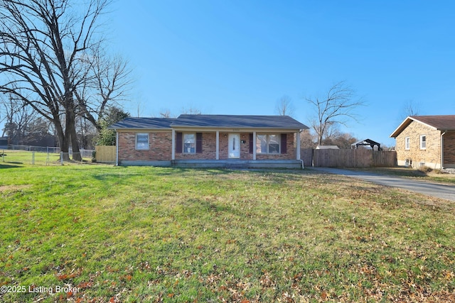 ranch-style house featuring a porch and a front lawn