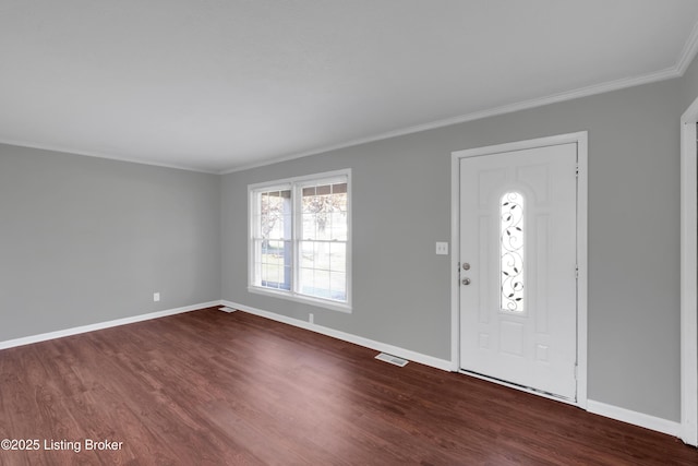 foyer with ornamental molding and hardwood / wood-style floors