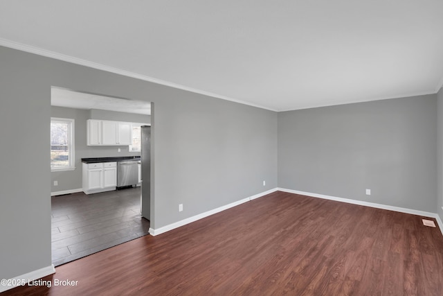 spare room with crown molding and dark hardwood / wood-style floors