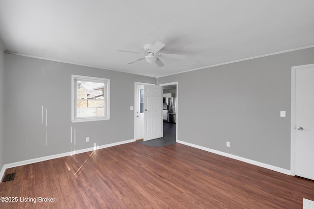 spare room with crown molding, ceiling fan, and dark hardwood / wood-style flooring