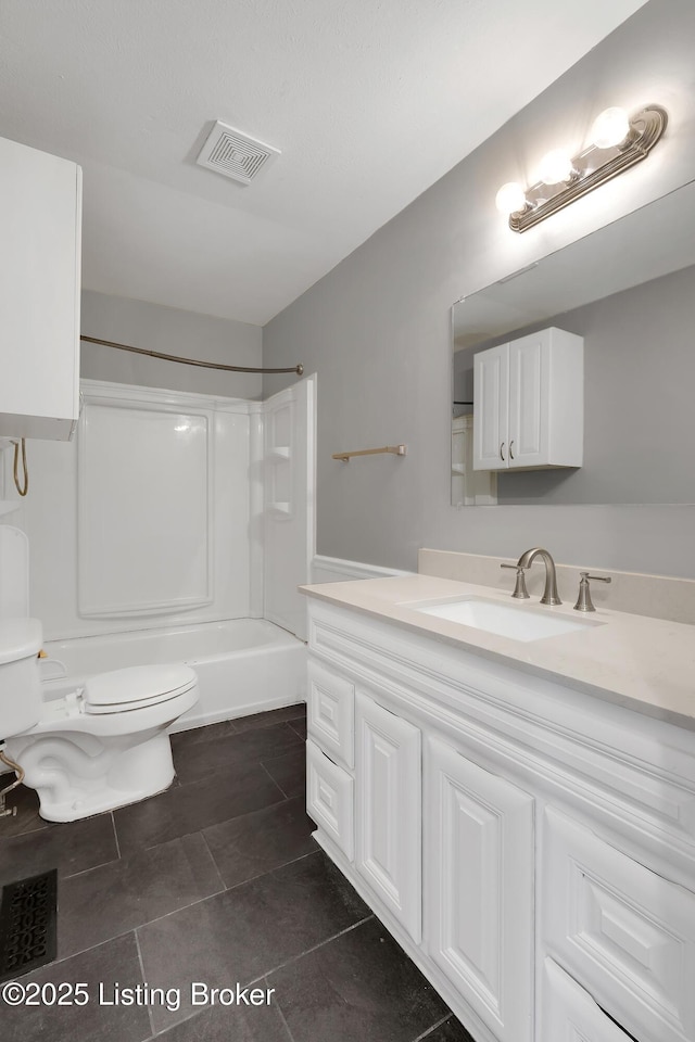 bathroom with vanity, tile patterned floors, and toilet