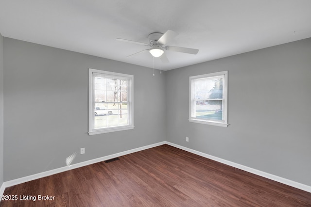 unfurnished room featuring hardwood / wood-style floors, a healthy amount of sunlight, and ceiling fan