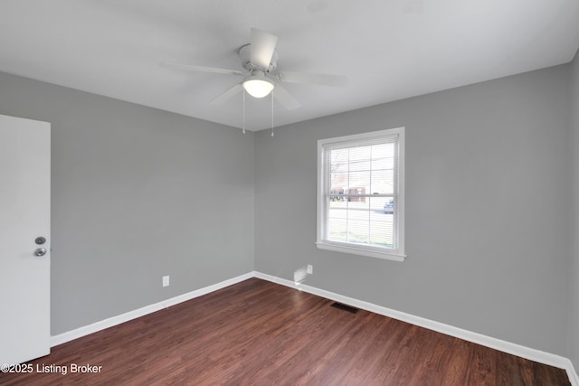 empty room with hardwood / wood-style floors and ceiling fan