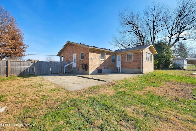 back of property featuring a yard and a patio