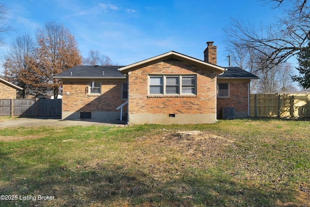 back of property with a yard, central AC, and a patio area