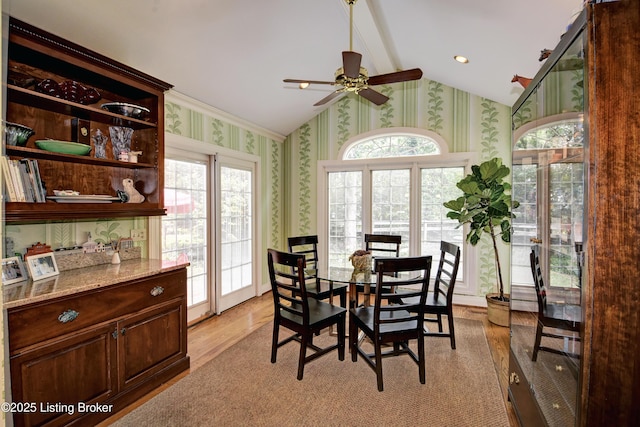 dining room with vaulted ceiling, ceiling fan, and light hardwood / wood-style flooring