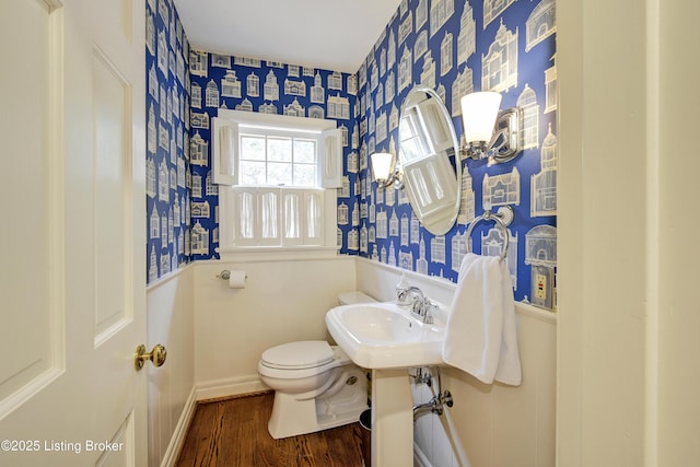 bathroom with sink, hardwood / wood-style flooring, and toilet