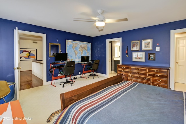 bedroom featuring ceiling fan and ensuite bath