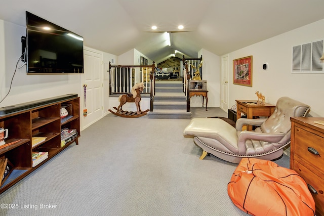 living area with vaulted ceiling and light carpet