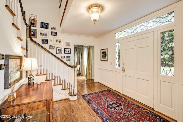 foyer entrance featuring hardwood / wood-style flooring and ornamental molding