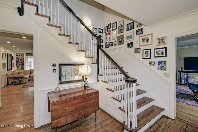 stairway featuring hardwood / wood-style flooring and ornamental molding