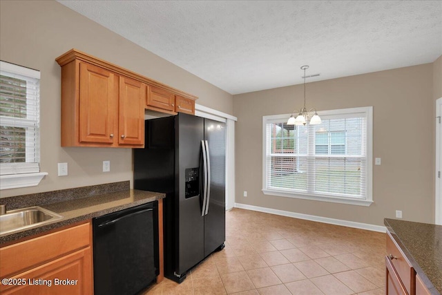 kitchen featuring stainless steel fridge with ice dispenser, a textured ceiling, light tile patterned floors, dishwasher, and a notable chandelier