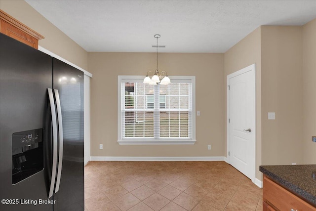 kitchen featuring light tile patterned flooring, a chandelier, stainless steel fridge with ice dispenser, a textured ceiling, and pendant lighting