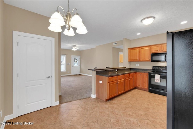 kitchen featuring light tile patterned floors, black appliances, kitchen peninsula, and a textured ceiling