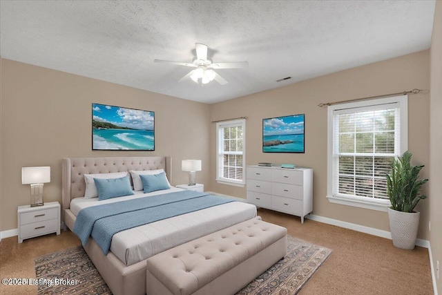 bedroom with ceiling fan and a textured ceiling