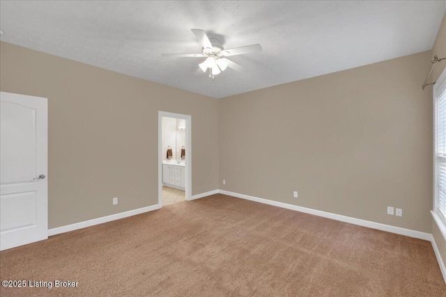 carpeted empty room featuring ceiling fan and a textured ceiling