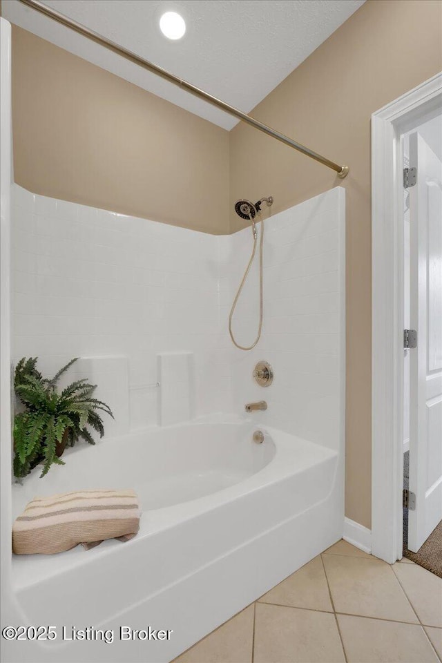 bathroom with tile patterned floors and bathtub / shower combination