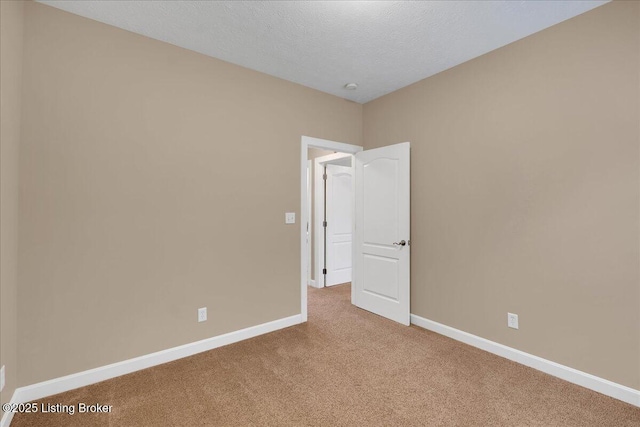 carpeted spare room featuring a textured ceiling