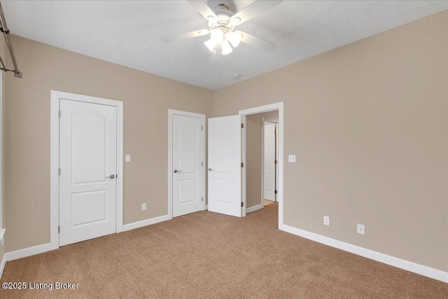 unfurnished bedroom with ceiling fan and light carpet