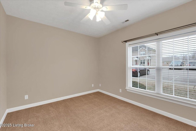 carpeted empty room featuring ceiling fan