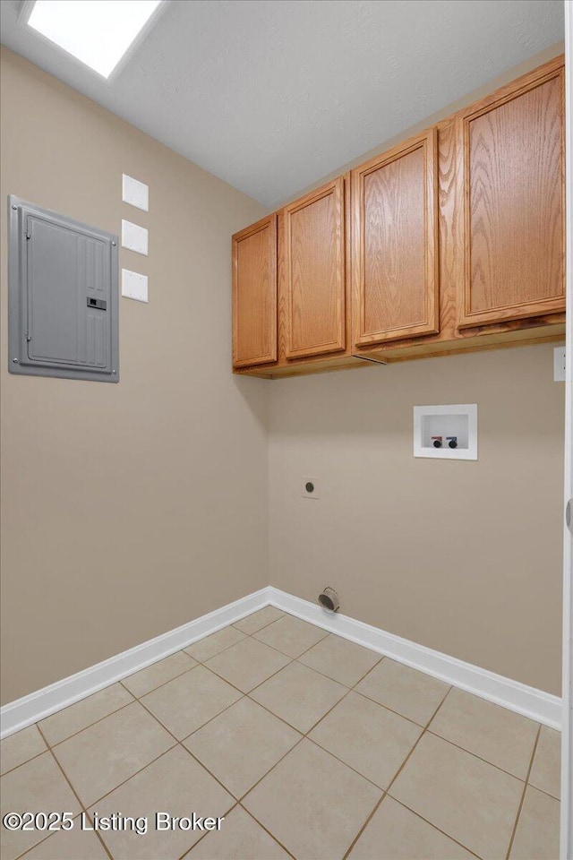 clothes washing area featuring light tile patterned floors, hookup for a washing machine, electric panel, cabinets, and hookup for an electric dryer