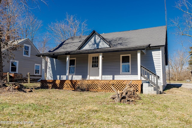 bungalow-style home featuring covered porch and a front lawn