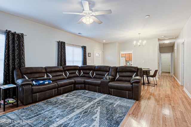 living room featuring light hardwood / wood-style flooring and ceiling fan