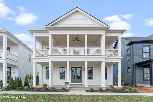 greek revival house featuring a porch, a balcony, and ceiling fan