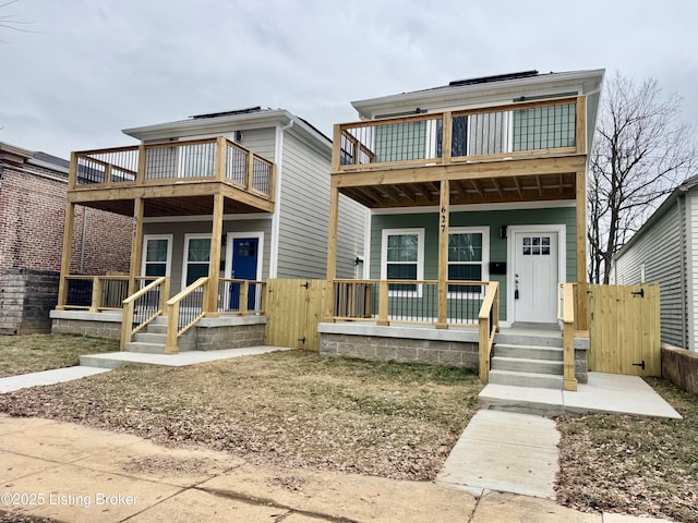 front facade featuring a porch and a balcony