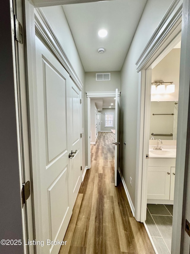 hall featuring dark hardwood / wood-style flooring and sink