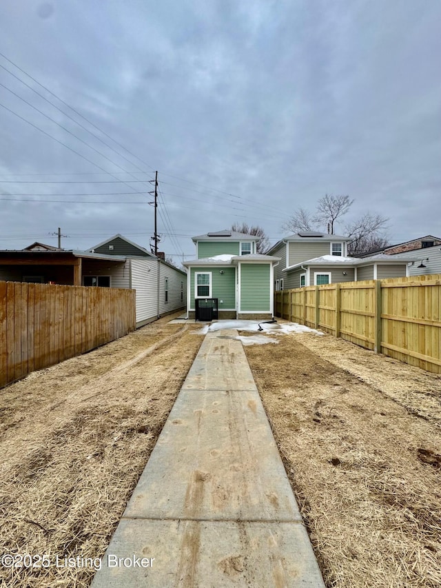 rear view of property with central AC unit