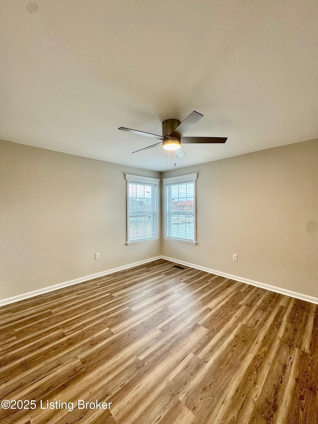 unfurnished room with wood-type flooring and ceiling fan