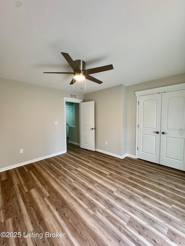 unfurnished bedroom featuring ceiling fan, light hardwood / wood-style floors, and a closet