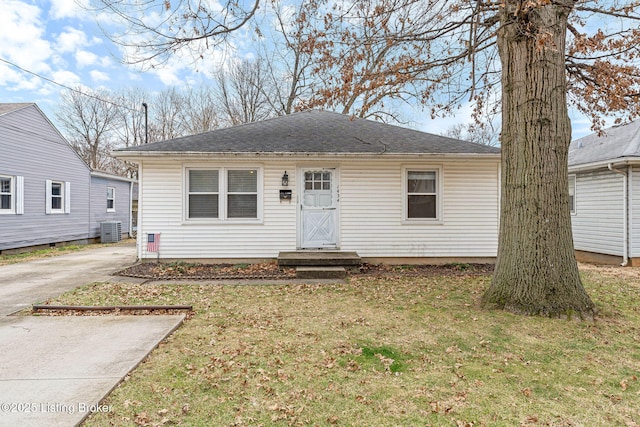 view of front of property featuring central AC and a front yard