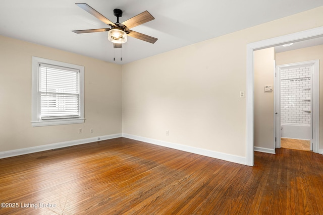 spare room featuring dark hardwood / wood-style floors and ceiling fan