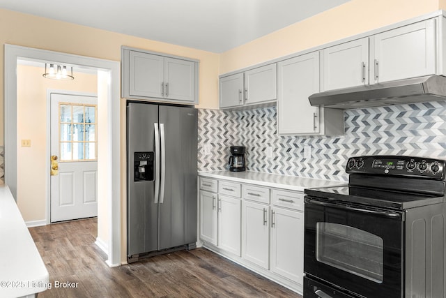 kitchen featuring tasteful backsplash, stainless steel fridge, dark hardwood / wood-style flooring, and black range with electric cooktop