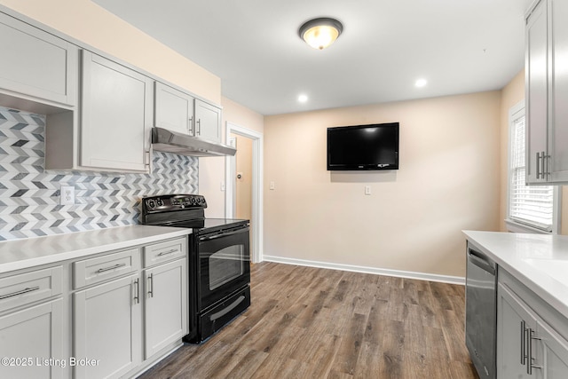 kitchen with dishwasher, hardwood / wood-style floors, decorative backsplash, and black range with electric cooktop