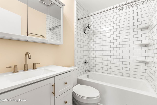 full bathroom featuring vanity, tiled shower / bath combo, and toilet