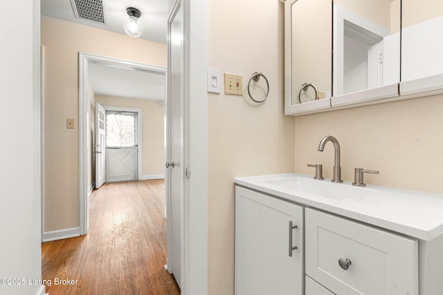 bathroom featuring vanity and hardwood / wood-style floors