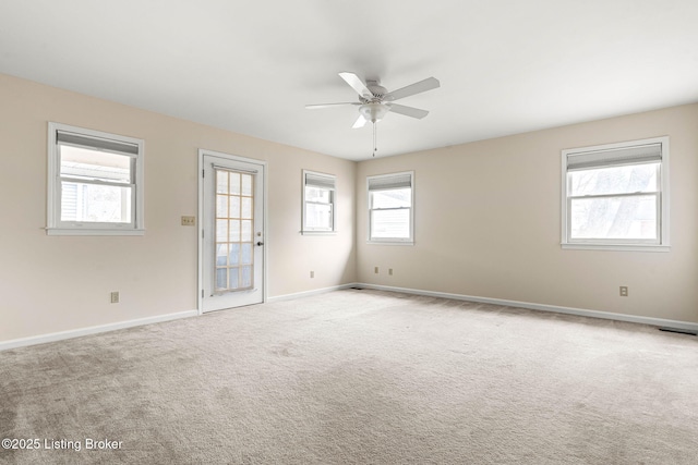 carpeted empty room featuring ceiling fan