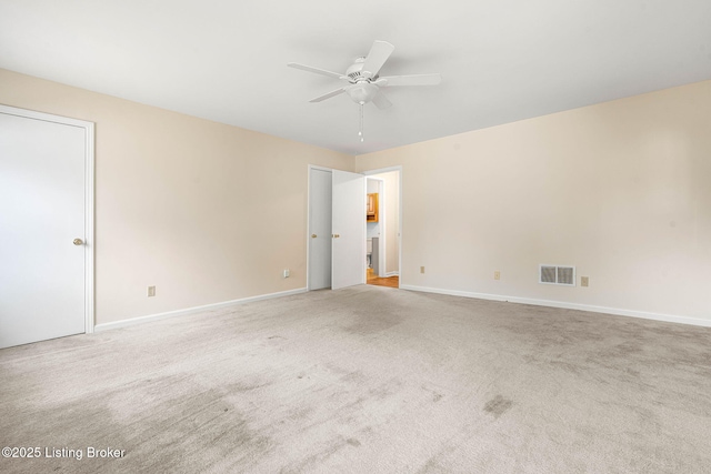 carpeted empty room featuring ceiling fan