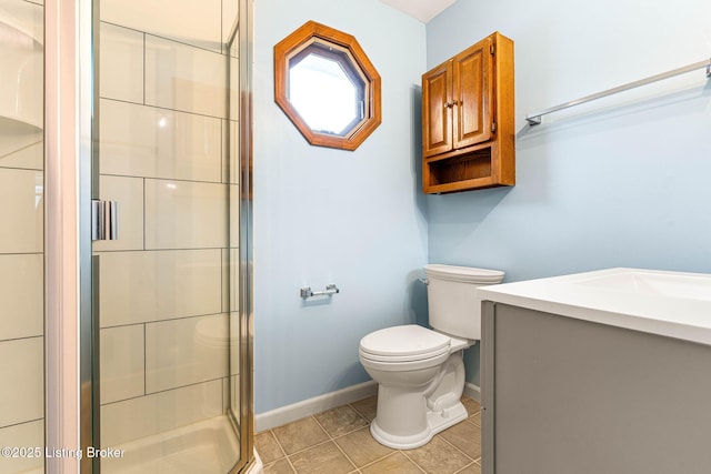 bathroom with vanity, tile patterned floors, a shower with door, and toilet