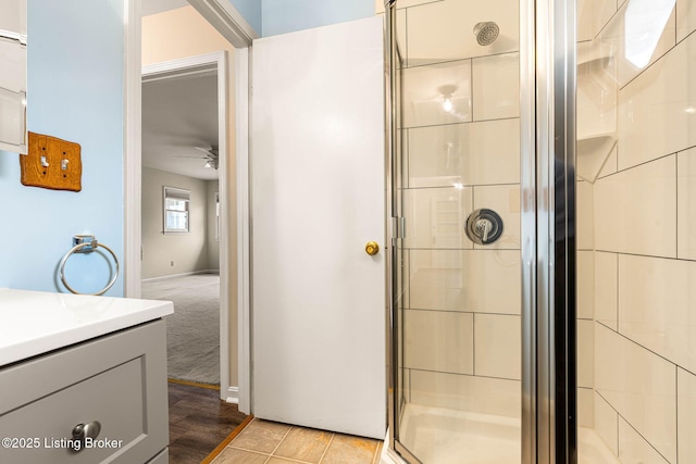 bathroom with ceiling fan, vanity, and an enclosed shower