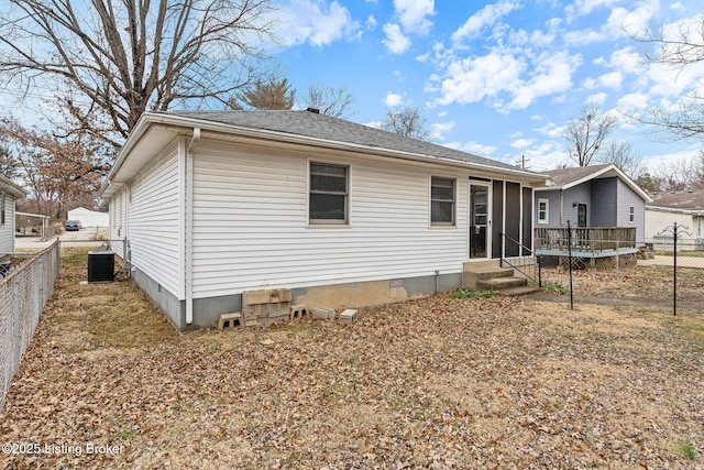 rear view of property with a wooden deck and central AC unit