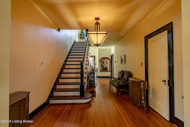 stairway with hardwood / wood-style floors