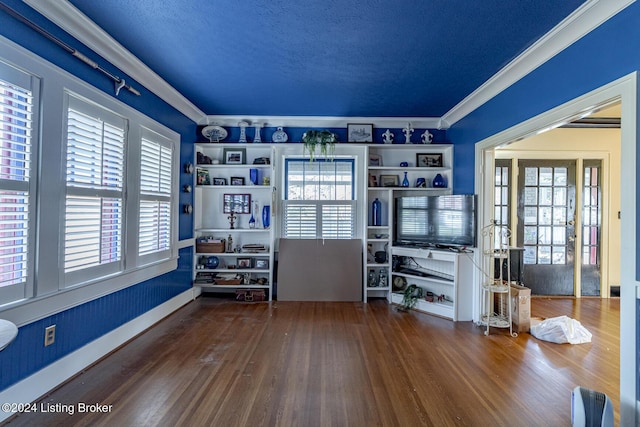 interior space featuring ornamental molding, dark wood finished floors, and a textured ceiling